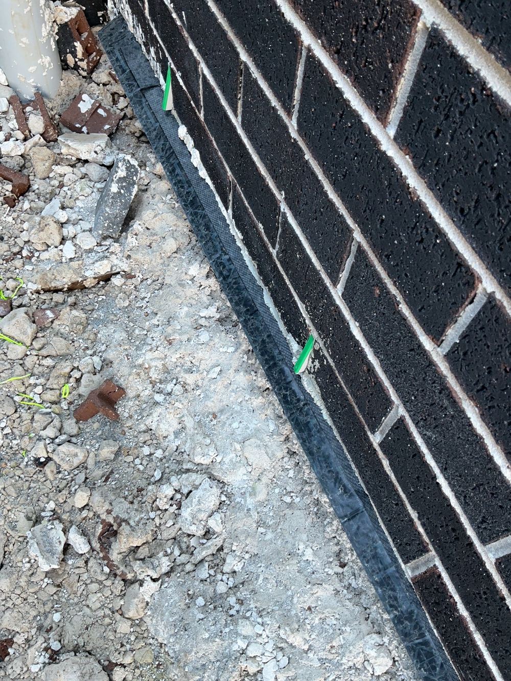Damp proof course left long and needing to be cut back, found during a fixing stage inspection in Cobbitty